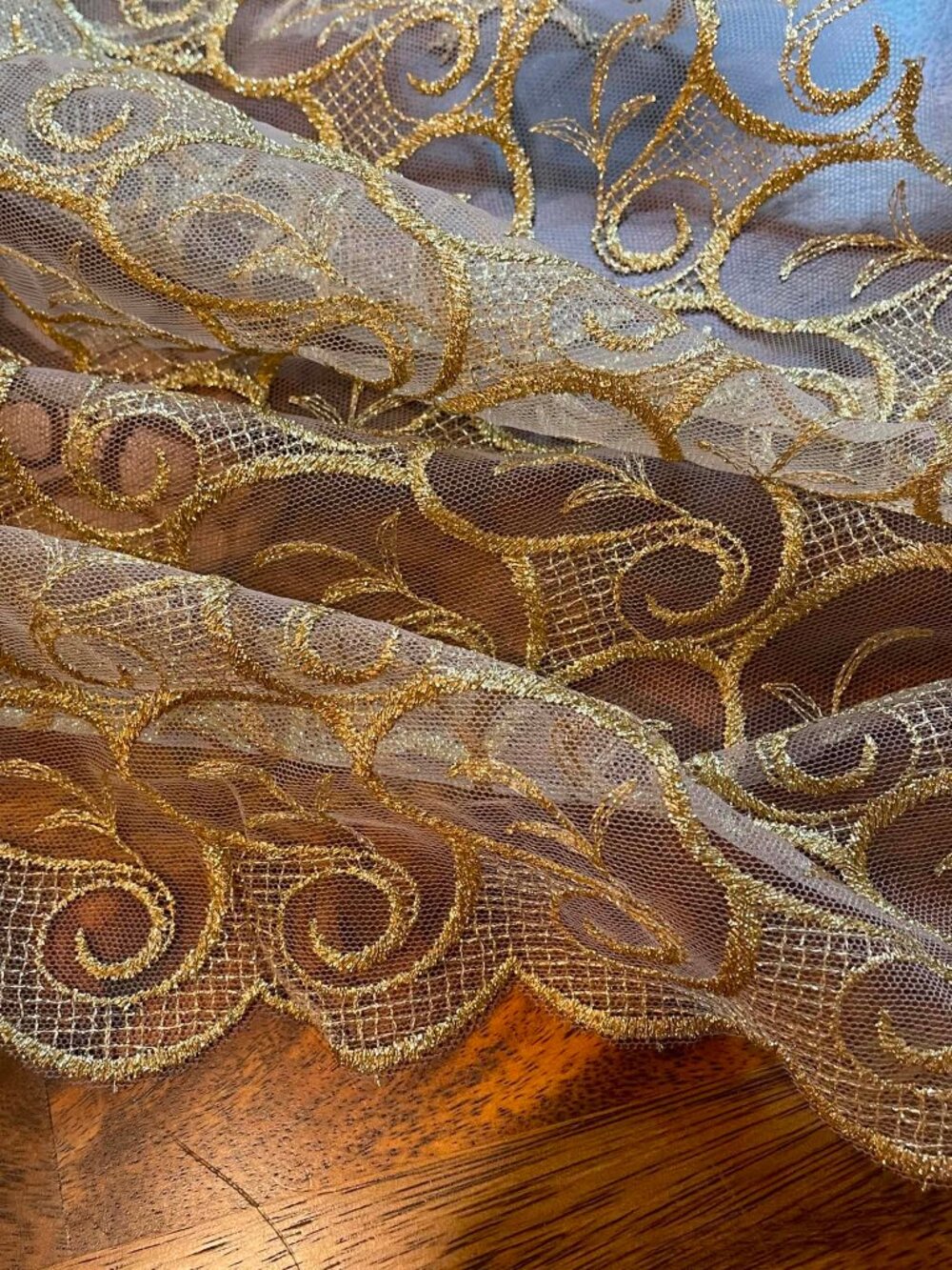 Metallic Gold All Over Lace fabric.  Scalloped on both edges.  Sold by the yard.